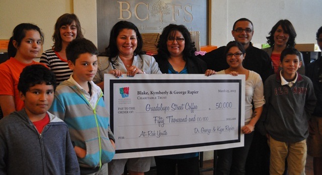 Photo: Coffee house staff and kids pose with the "big check"